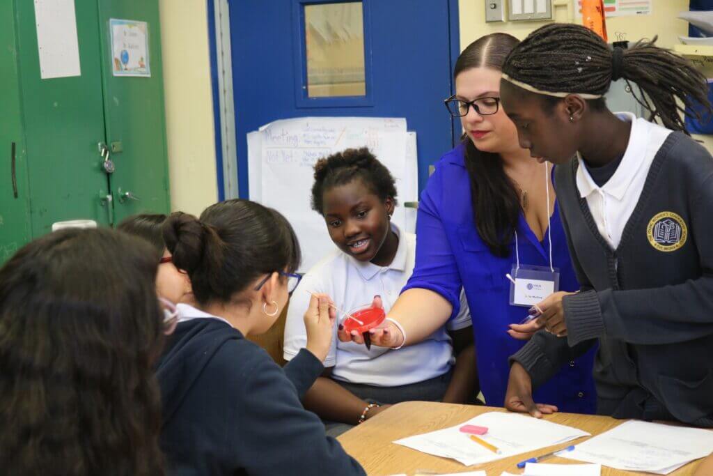 TYWLS students and CWHJ volunteer doing hands on project