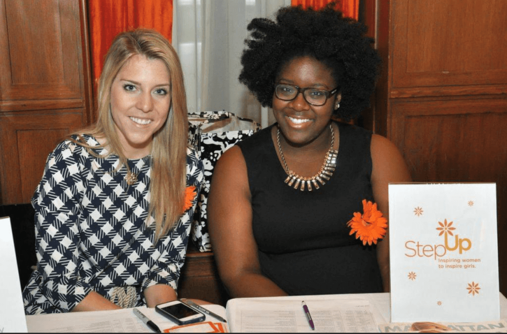 Kristen as a high school student is sitting next to a volunteer at a Step Up event.