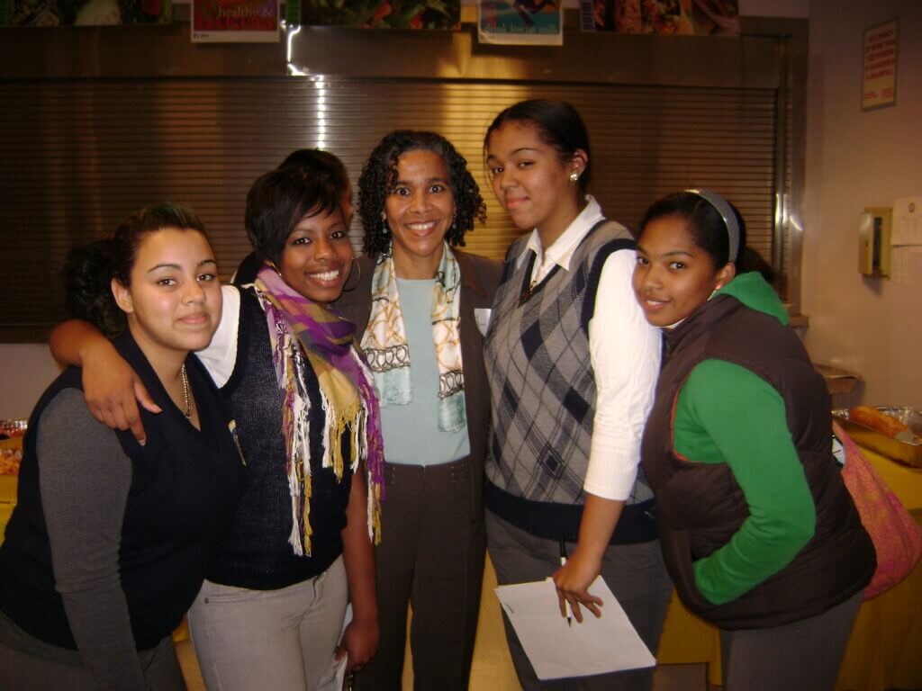 Sara Clarke takes a group photo with TYWLS students at a Jumpstart To College event. 