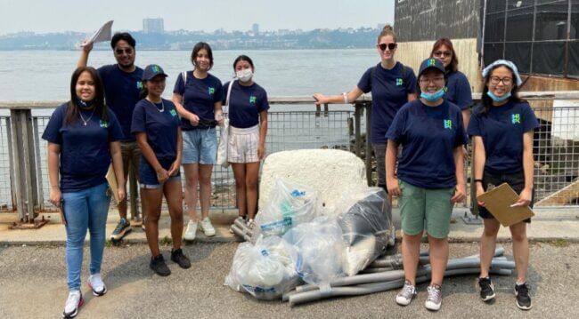 A group of TYWLS students pose for the camera with a bag of trash collected on and along the Hudson River.
