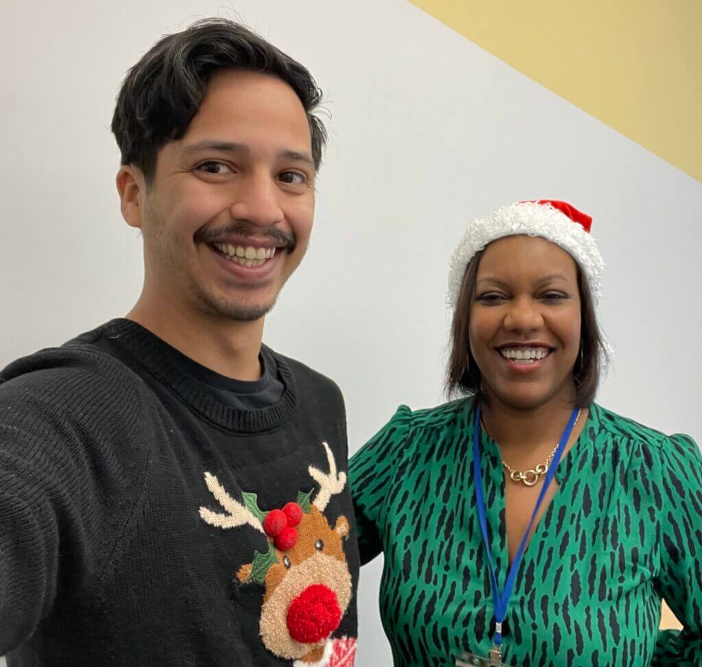 Roberto Diaz and Dora Mendez are wearing festive holiday attire.