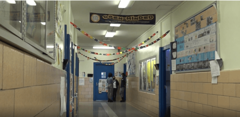 A hallway at TYWLS Bronx with a banner that says 'Open Minded'.