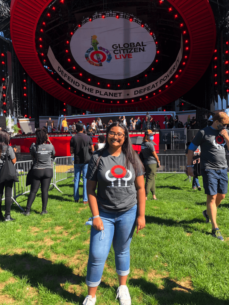 Michelle stands in front of the Global Citizen stage.