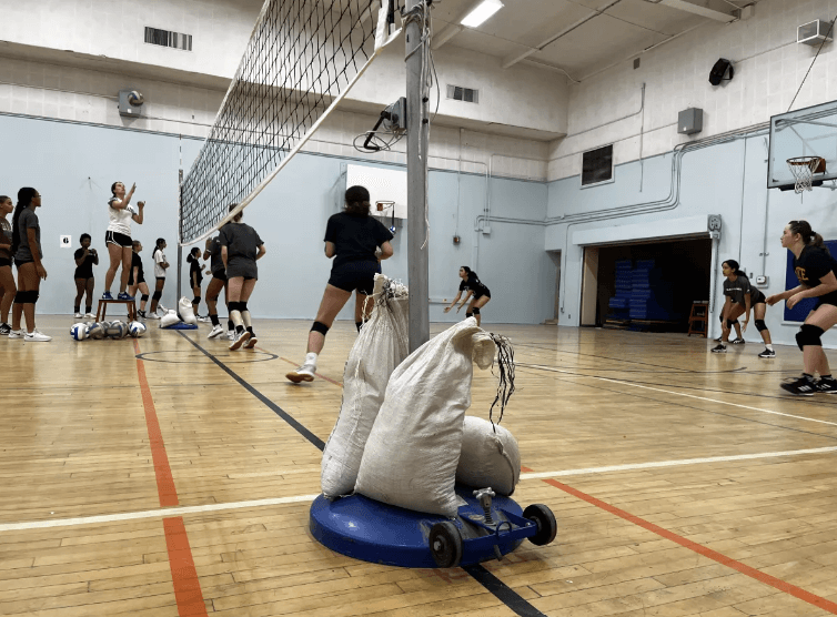 GALA volleyball team practices with a net they engineered using a pulley and lever system