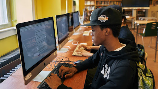 A high school student works on computer in the school's college office
