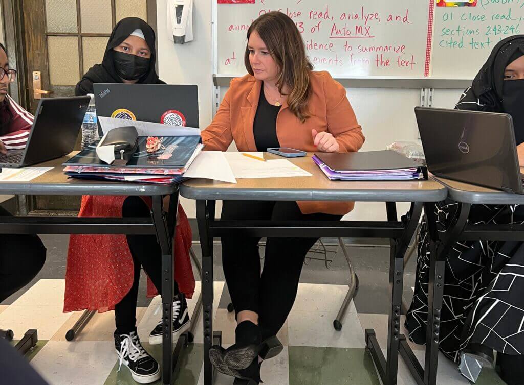 Joell assists a student with their financial aid paperwork.