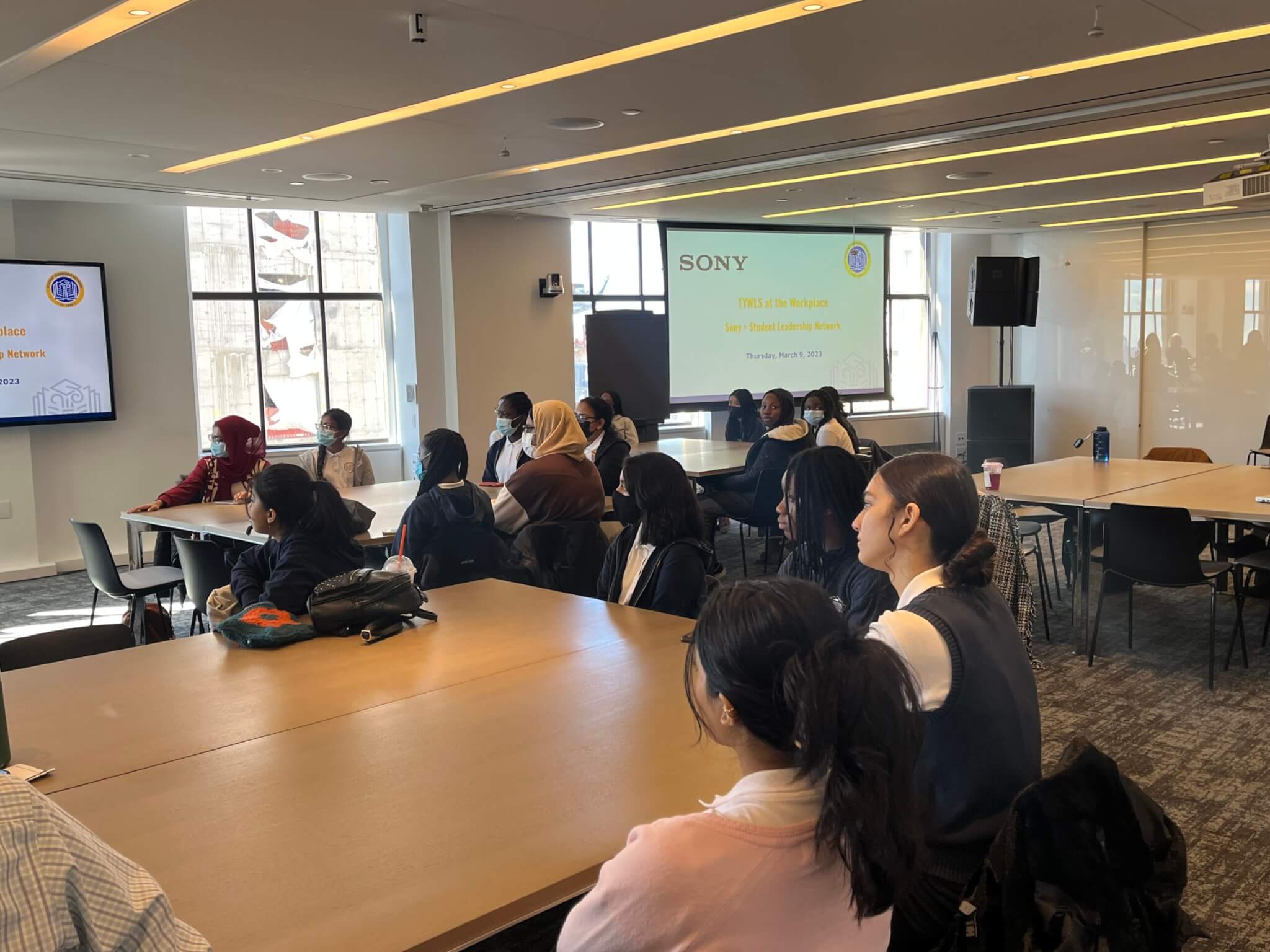 Students listen thoughtfully to a employee panel.
