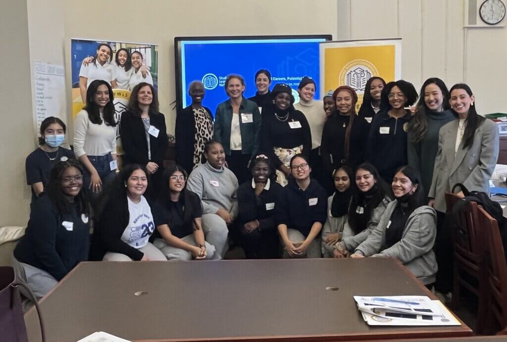 Group of students and volunteers pose at TYWLS Brooklyn.