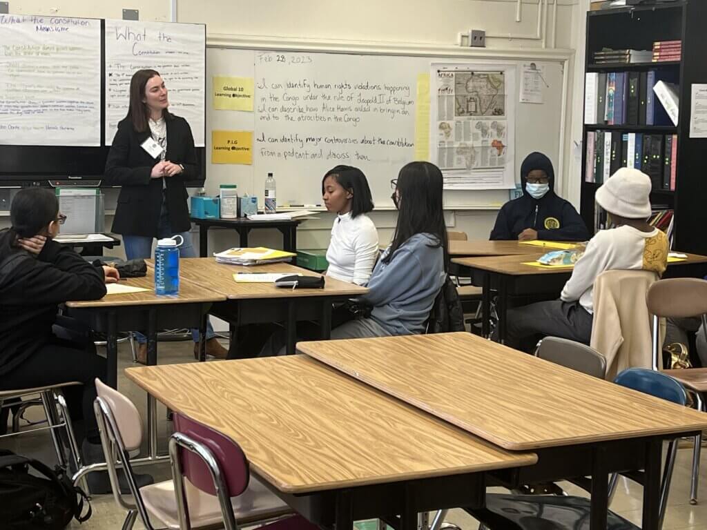Volunteer talks to students about her job at PepsiCo
