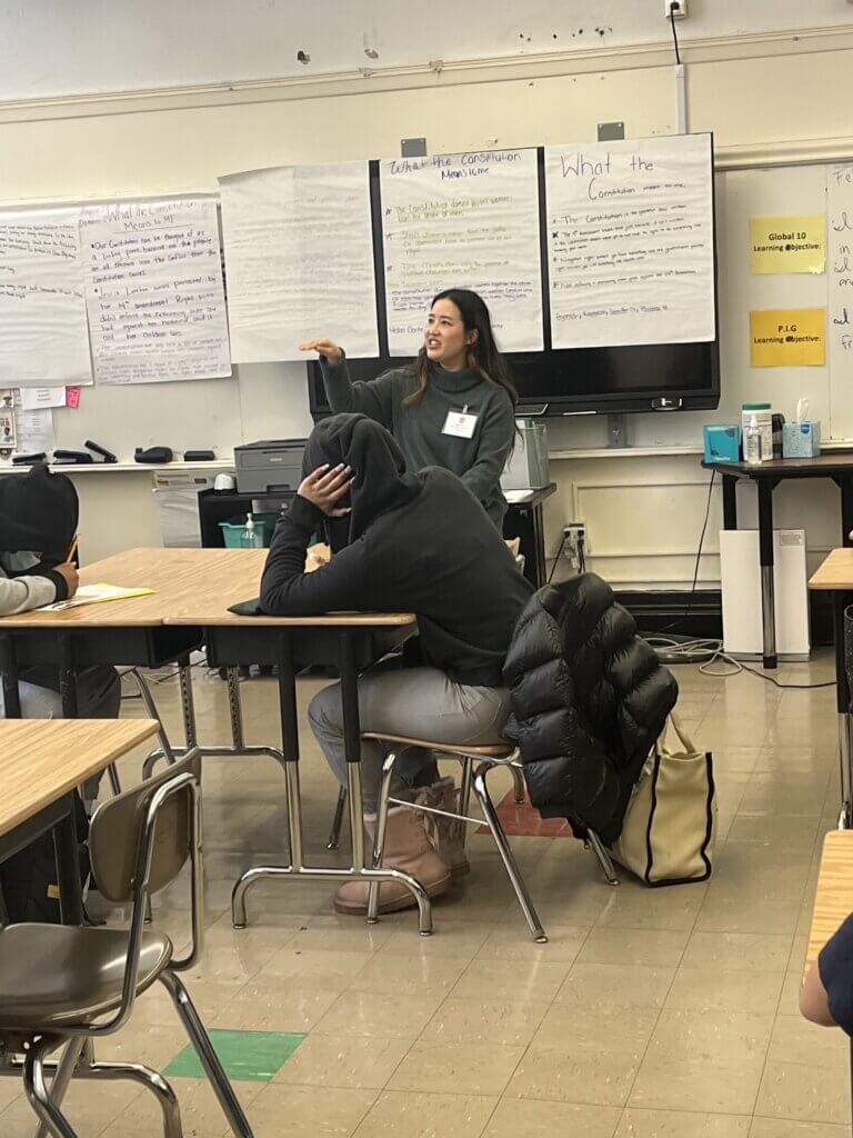 An employee from The Estee Lauder Companies talks to students about her job.