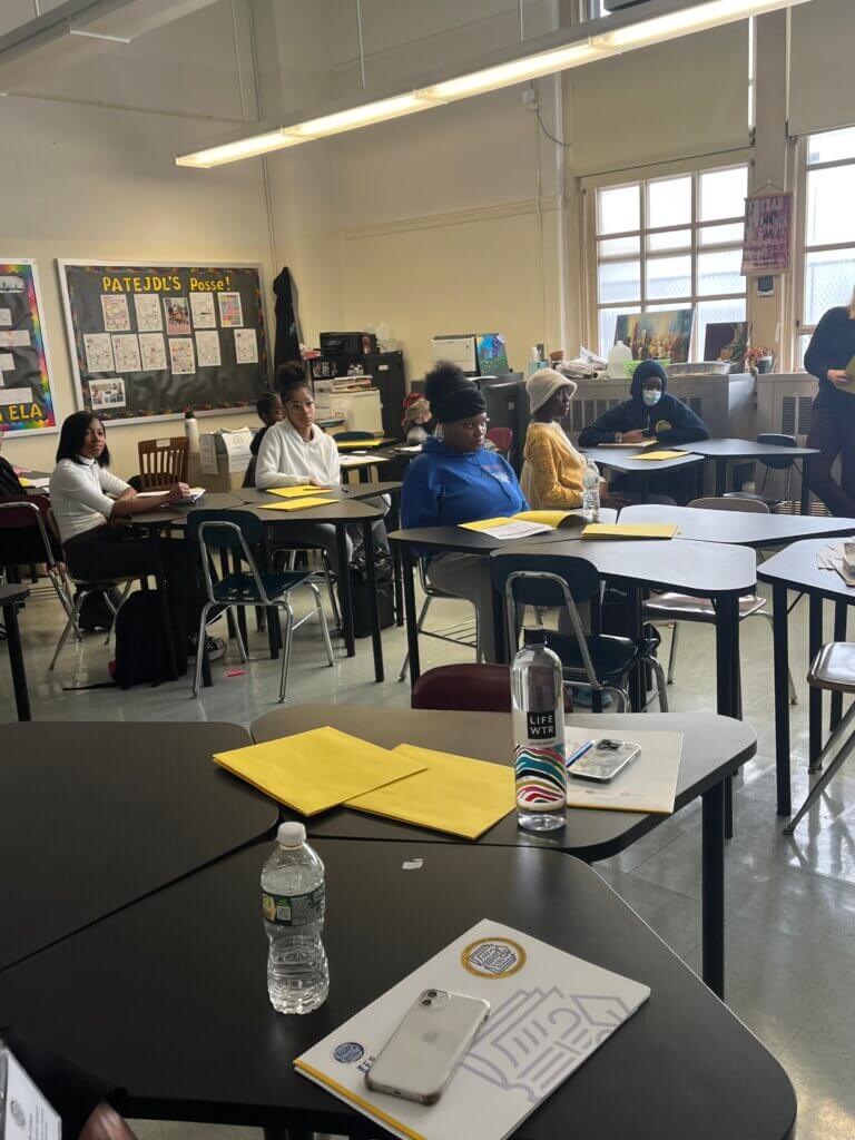 Students listen thoughtfully to a volunteer presentation.