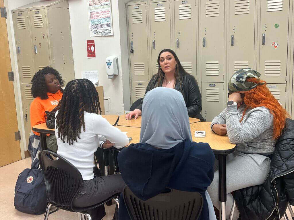 Students talk to an employee from MAC Cosmetics about her work.