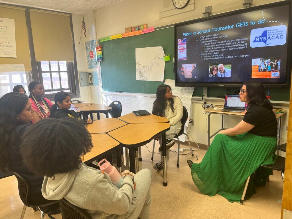 Students learn about the work of a school counselor from a volunteer.