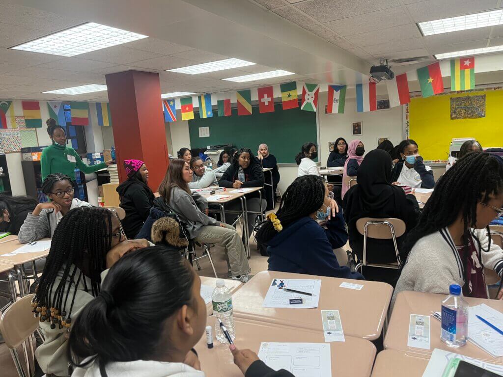 Students listen thoughtfully to a volunteer presentation.