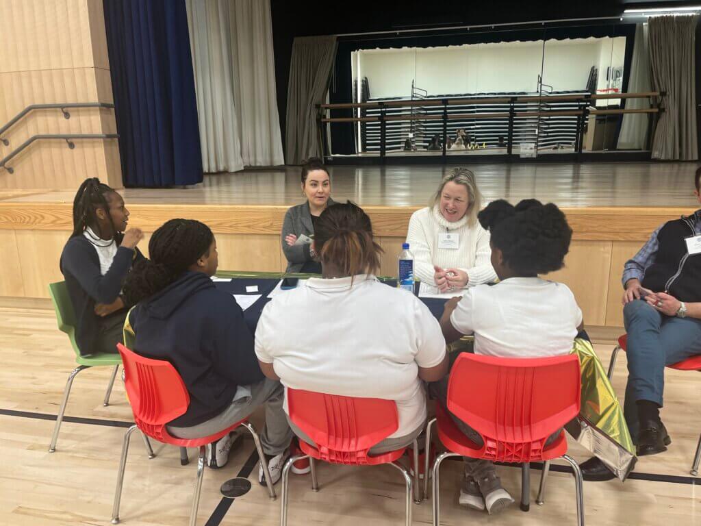 Students talk to employees from The Estee Lauder Companies about their work.