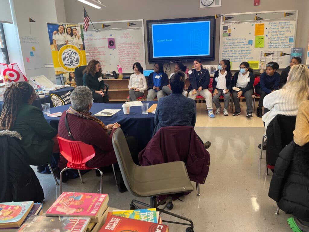 Volunteers listen to a student panel at TYWLS Staten Island.
