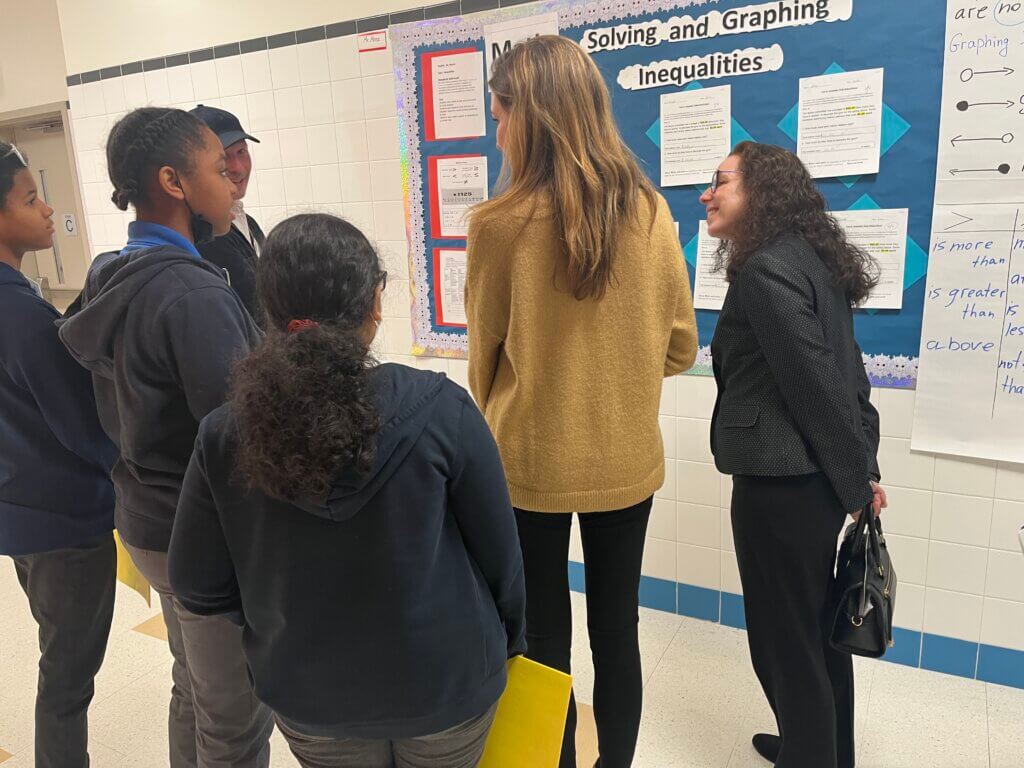 Student ambassadors give volunteers a tour of their school.