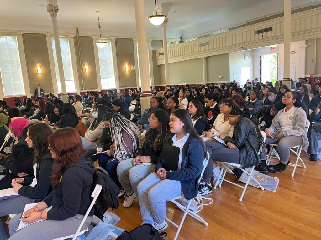 Students listen thoughtfully to the presentation by Regine Roy.