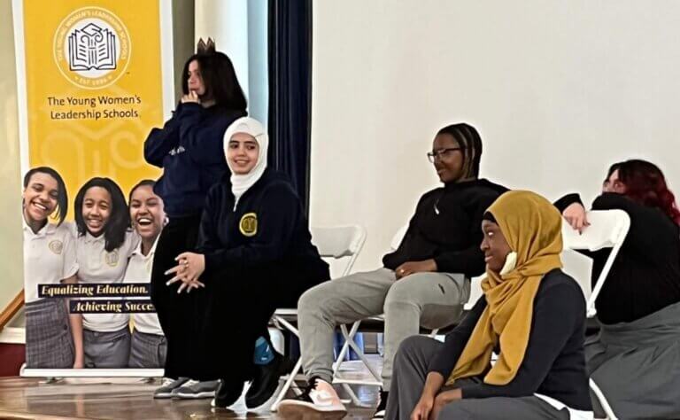 Students participate in an activity where they demonstrate "sitting on their thrones."
