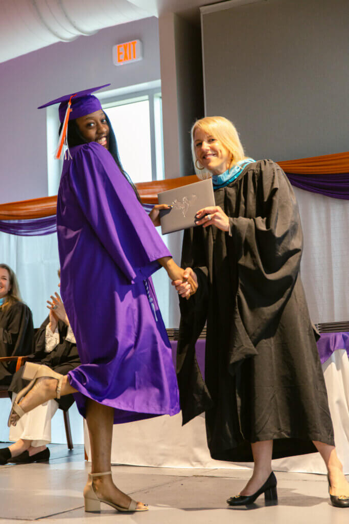 Graduating student receives diploma from the principal