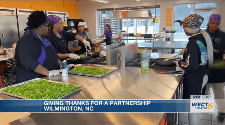 High school students cooking vegetables in culinary class