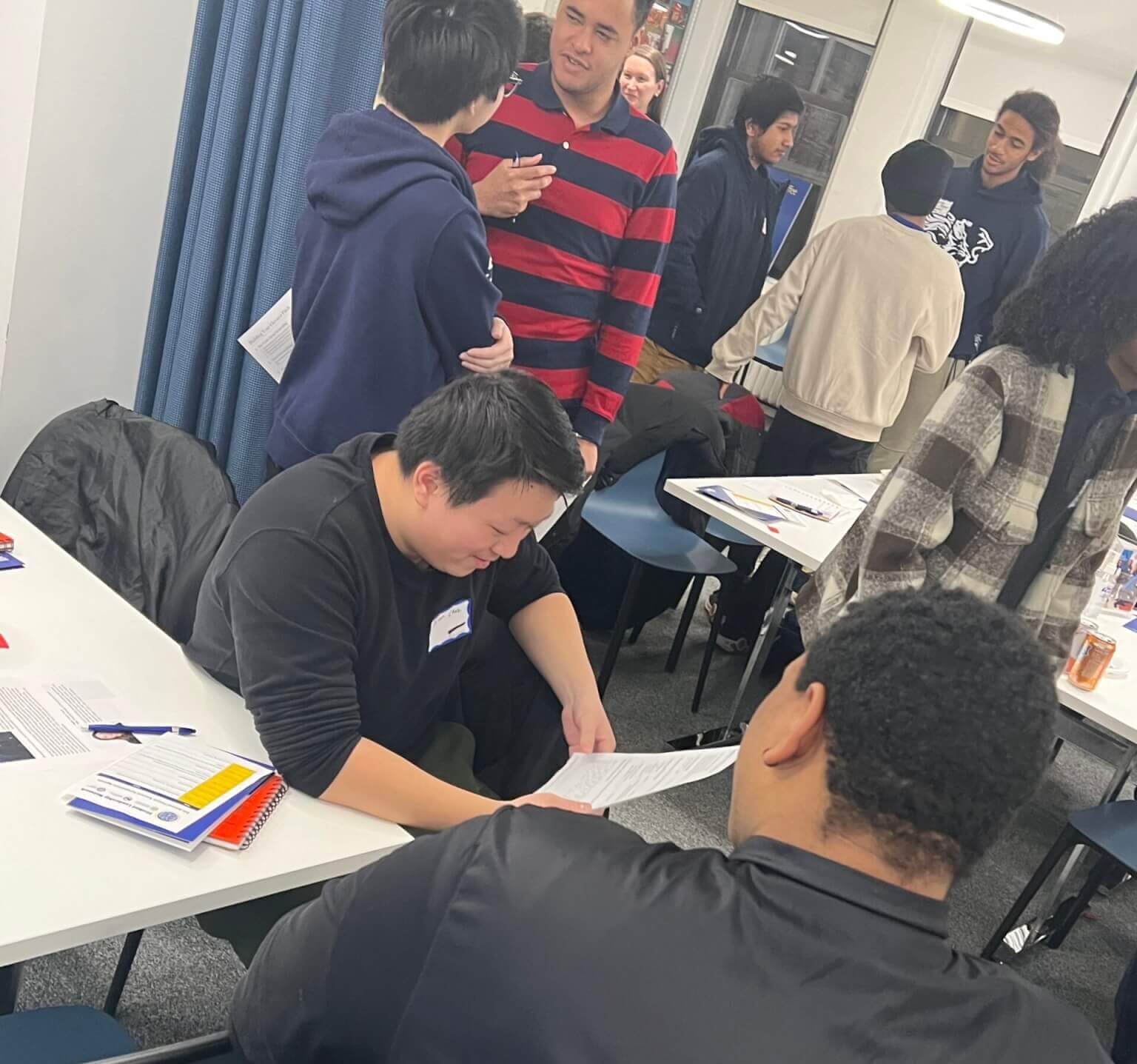 Alumni in pairs practice their elevator pitches and review resumes