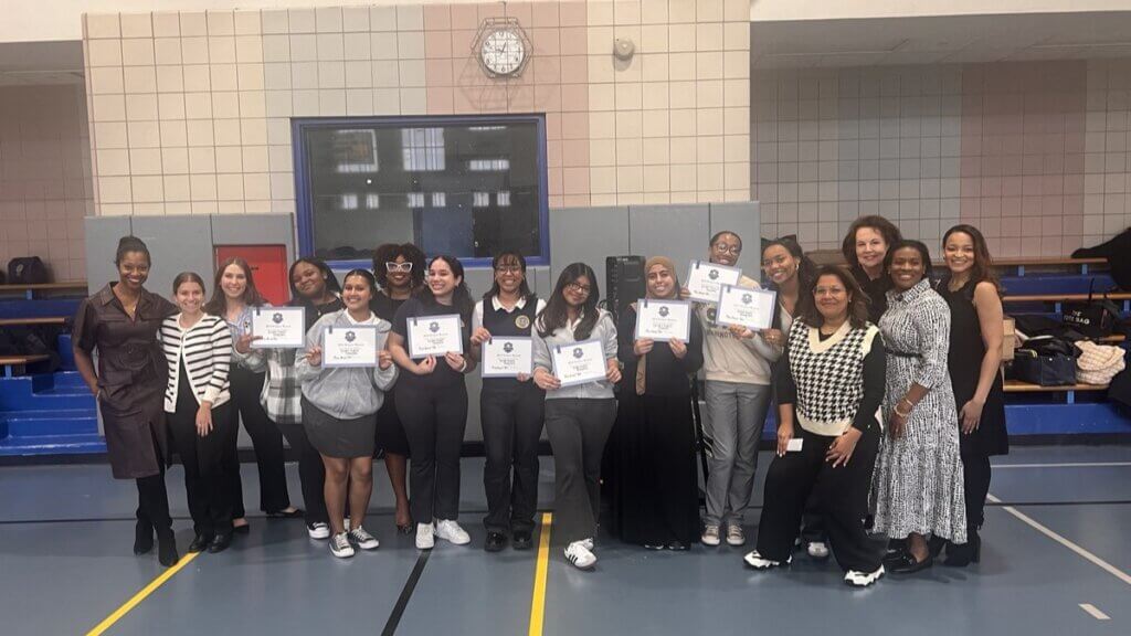 Students hold up certificates for winning the product pitch competition