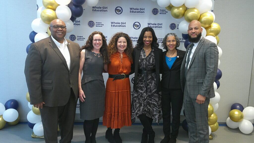 Six members of Student Leadership Network's leadership team pose for photo in front of balloons