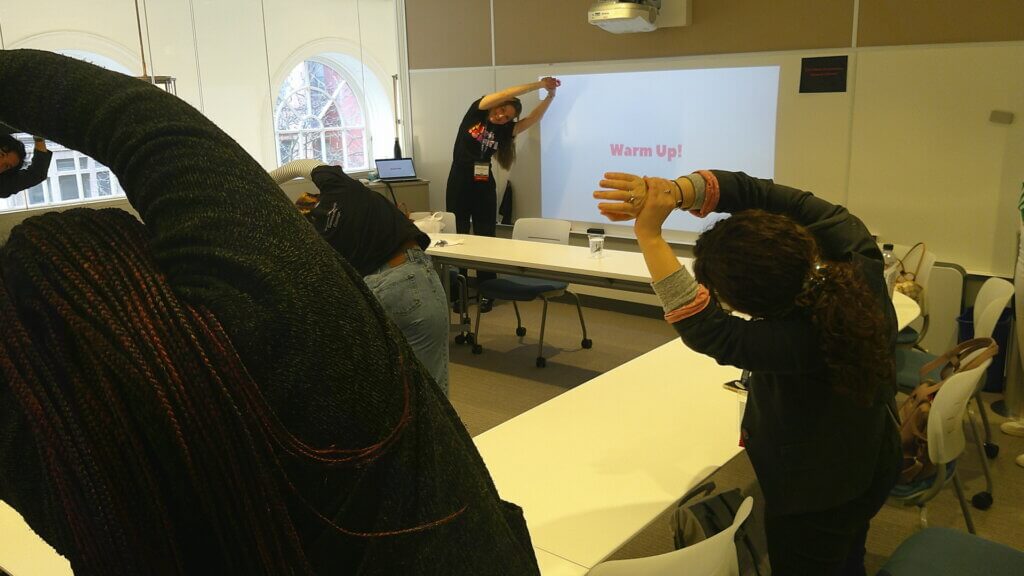 Adults stretch to their side with arms over their heads