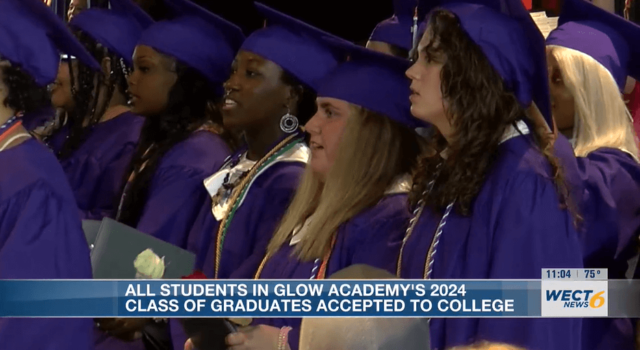 Five young women wear purple graduation caps and gowns at their high school graduation ceremony