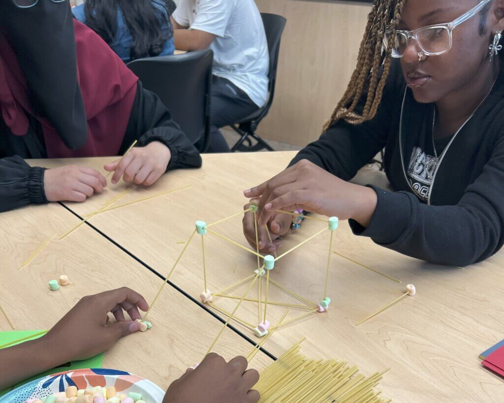 Students construct a 3-D structure with marshmallows and spaghetti