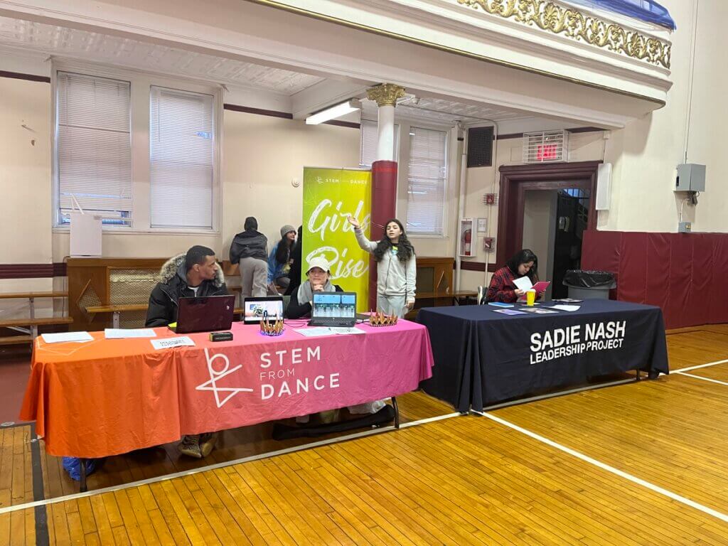 Summer opportunity fairs with nonprofits tabling in a school gym