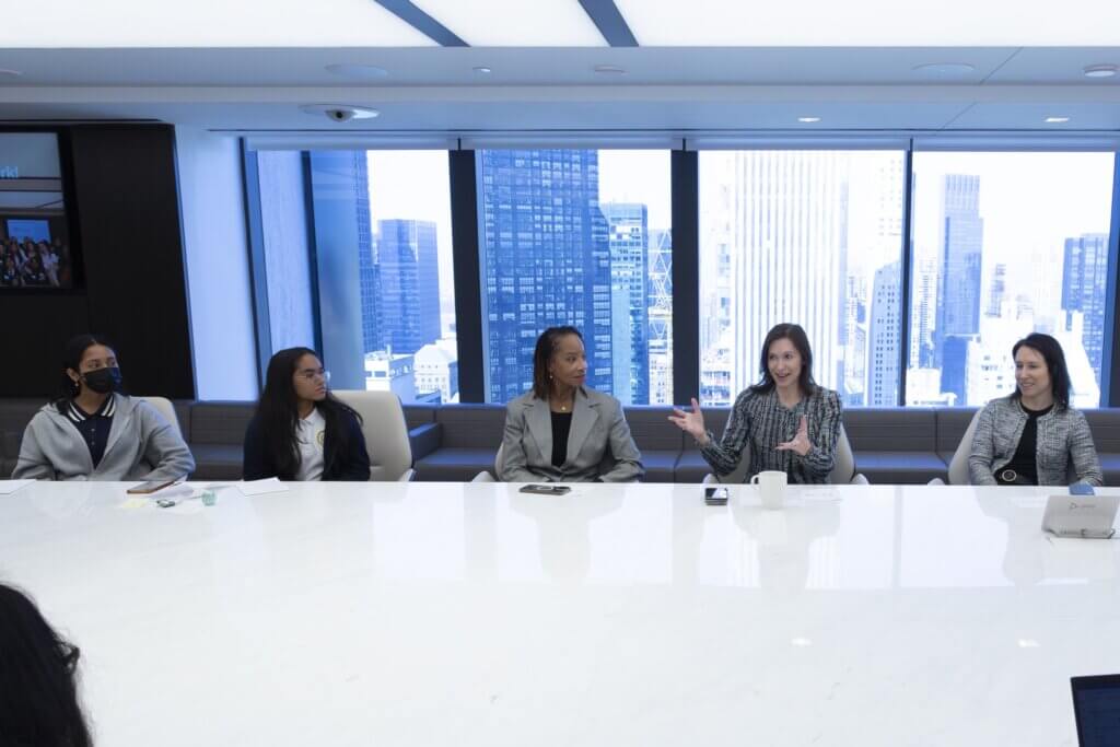 Apollo team members and students are seated at long conference table