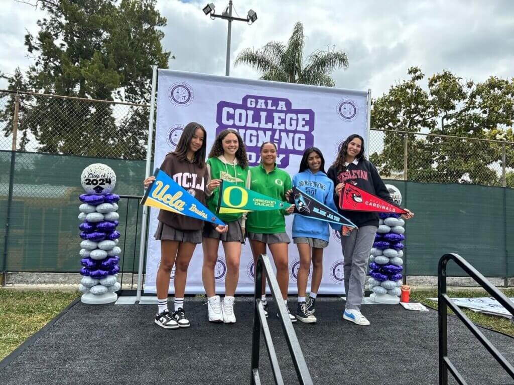 GALA students pose and hold college pennants at their College Signing Day celebration. 