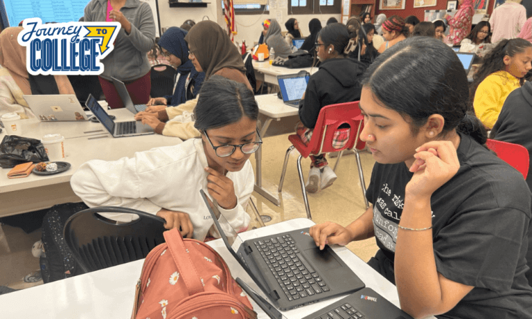 students on laptops work together