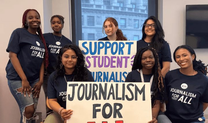 Six female students wear coordinated t-shirts and hold up signs that say Journalism for All