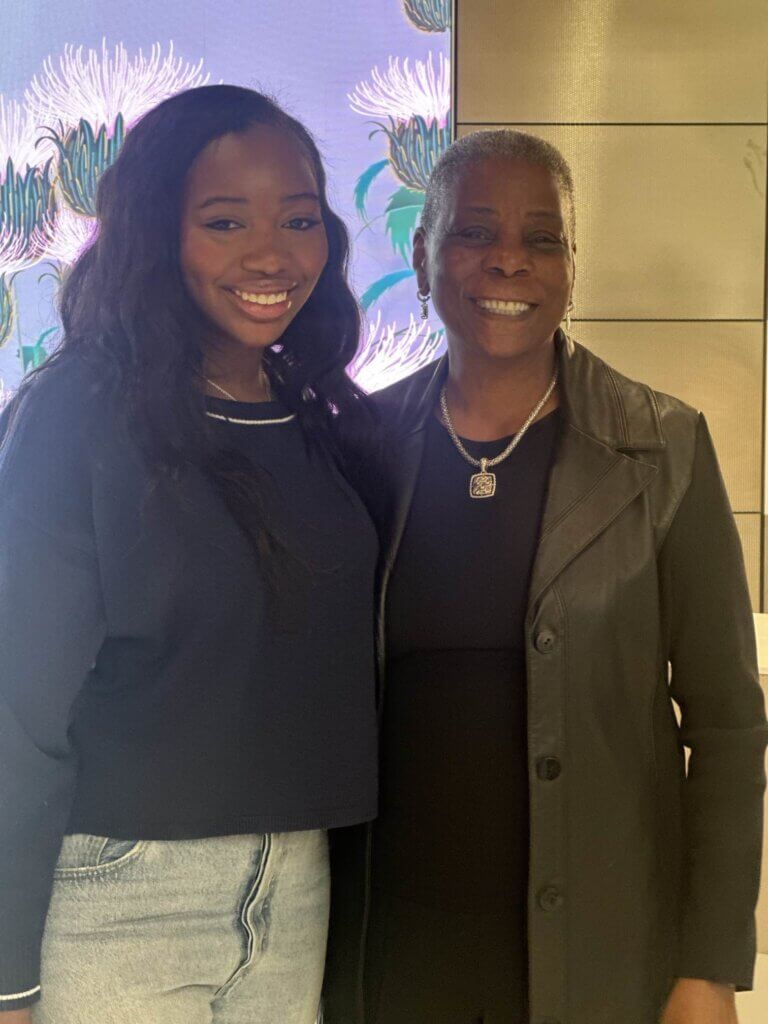 Female student poses for photo with Ursula Burns