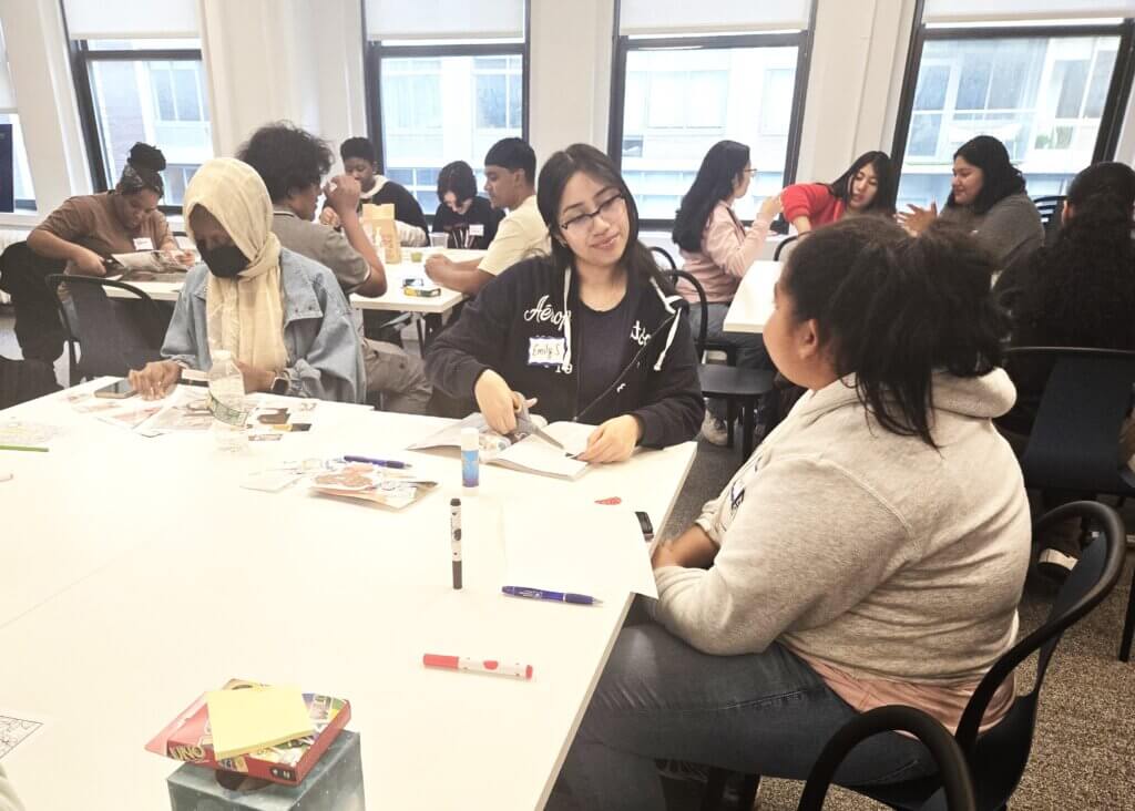 College students create vision boards with cutouts from magazines