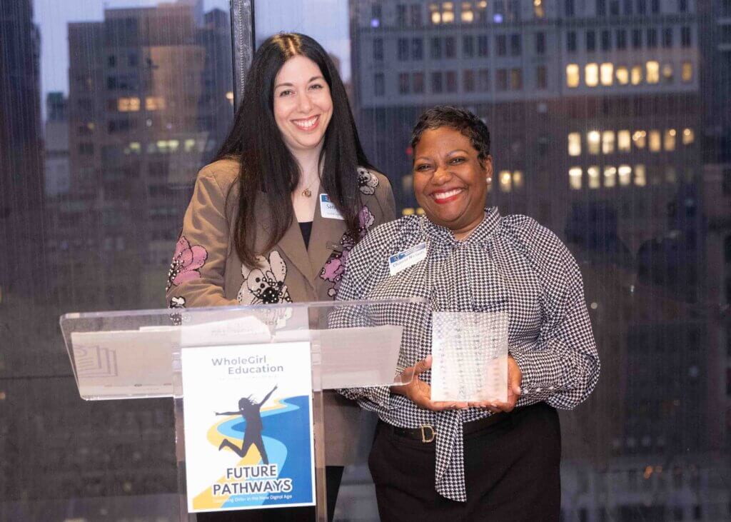 Sarah Boldin presents Charcia Nichols with an award plaque