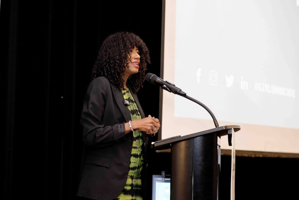 Tarika Barrett speaks at podium