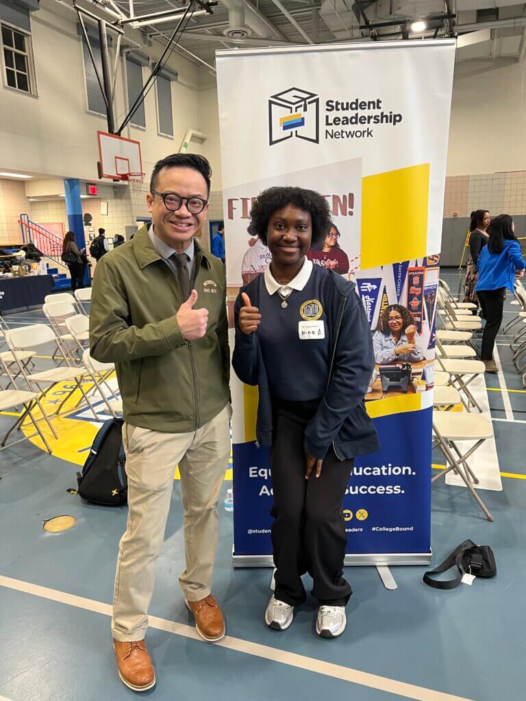 An ROTC volunteer with a student guide at a school event