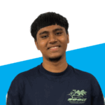 A young man with short, dark hair smiles at the camera