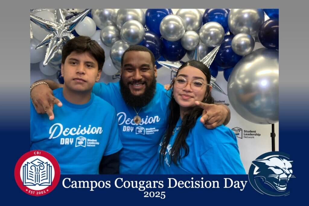 Three people wearing matching blue Decision Day shirts pose and smile in front of a balloon display at Campos Cougars Decision Day 2025 event.