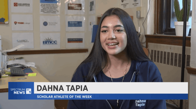 A young woman sits indoors, smiling in front of educational posters, with a news graphic identifying her as Dahna, Scholar Athlete of the Week
