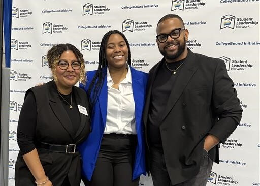Three people standing and smiling in front of a backdrop with Student Leadership Network and CollegeBound Initiative logos,