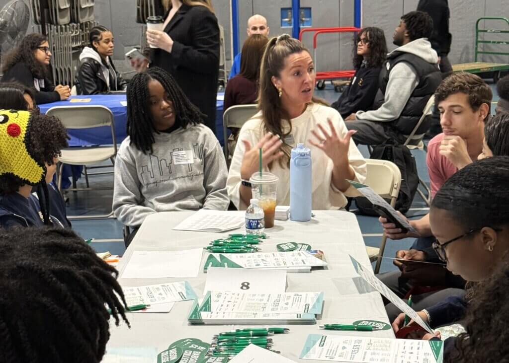 college rep and students talk with each other at small roundtable