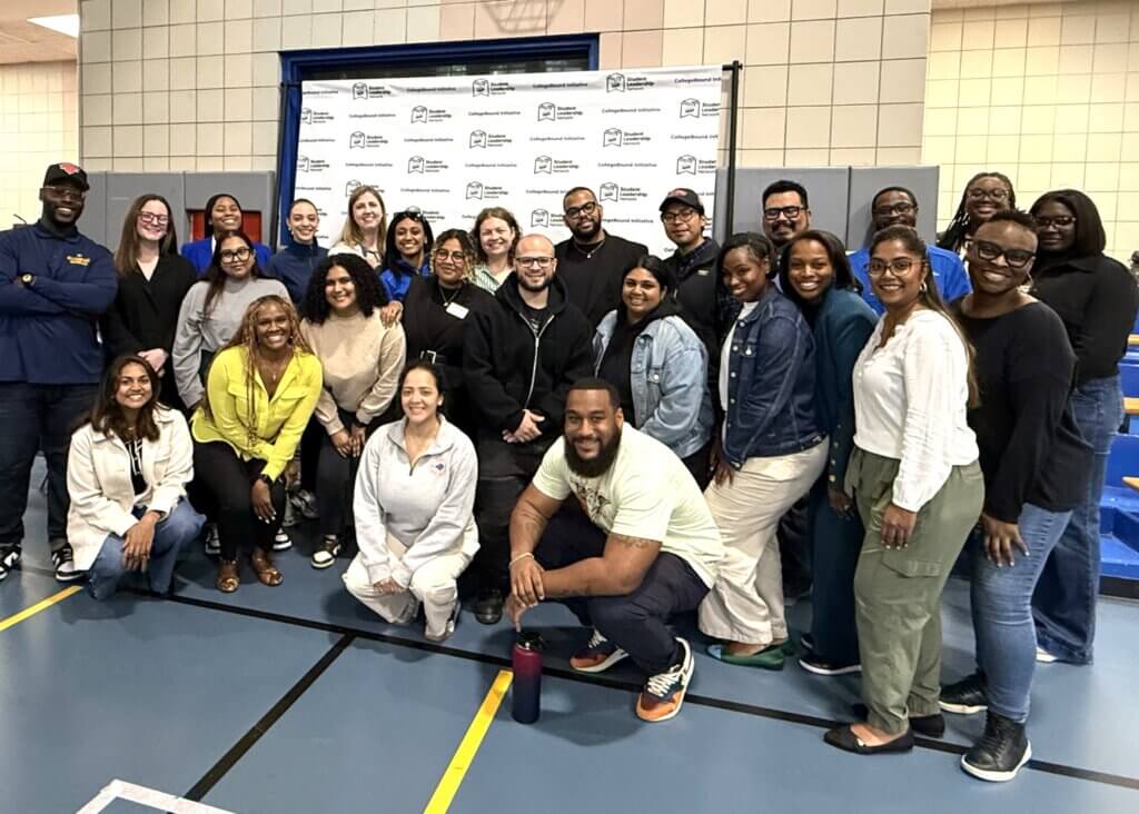college counselors pose for photo in front of CollegeBound Initiative step and repeat banner