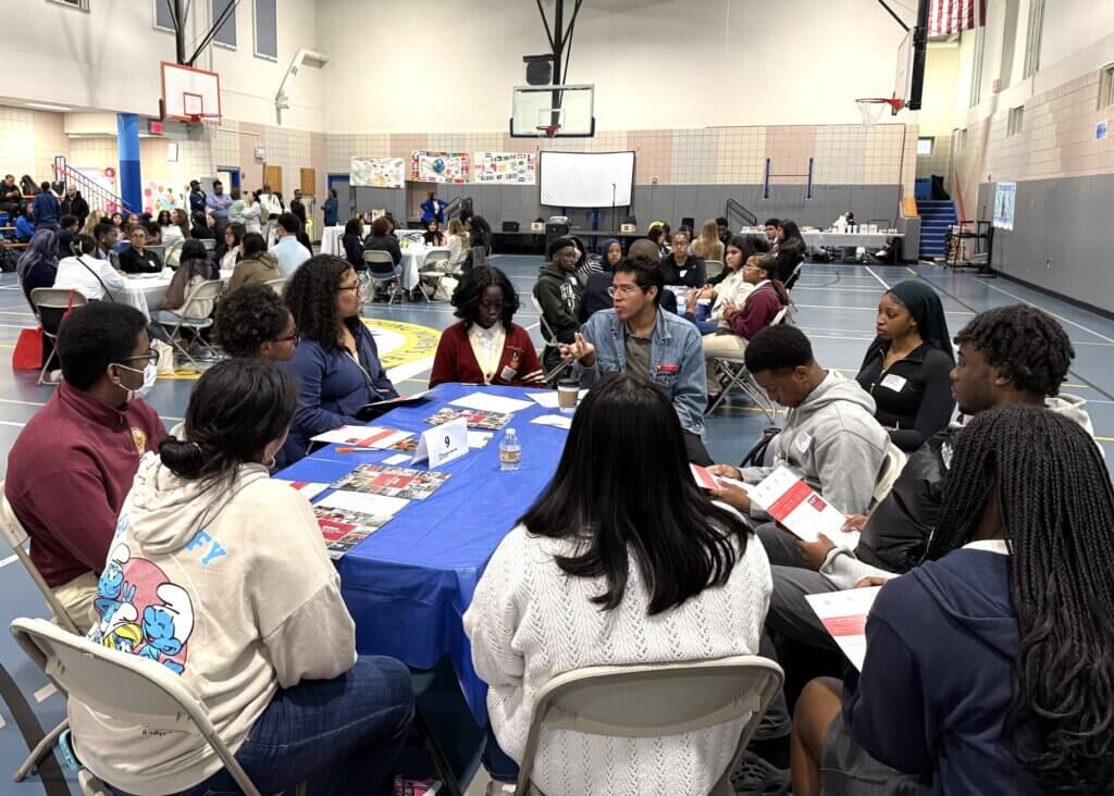college rep and students talk with each other at small roundtable