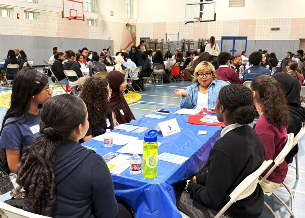college rep and students talk with each other at small roundtable