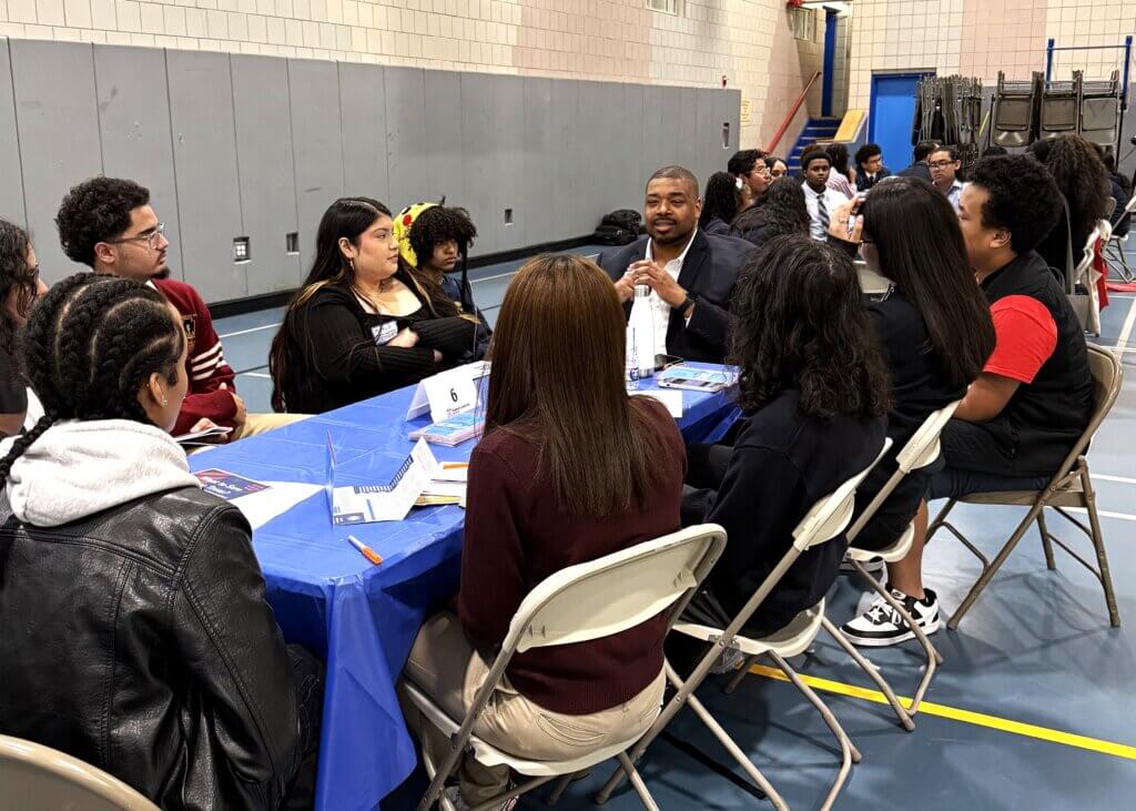 college rep and students talk with each other at small roundtable